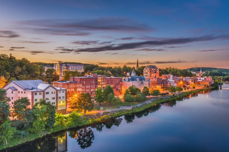 Augusta, Maine skyline viewed from across river at dusk.